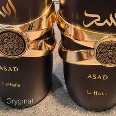 Dwa flakony perfum ASAD Lattafa. Czarny, luksusowy flakon z złotymi zdobieniami i wizerunkiem lwa. Oryginał.