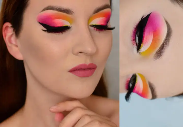 Oczy z wyrazistym makijażem typu cut crease w odcieniach różu, pomarańczy i żółci. Czarne kreski i długie rzęsy podkreślają spojrzenie.