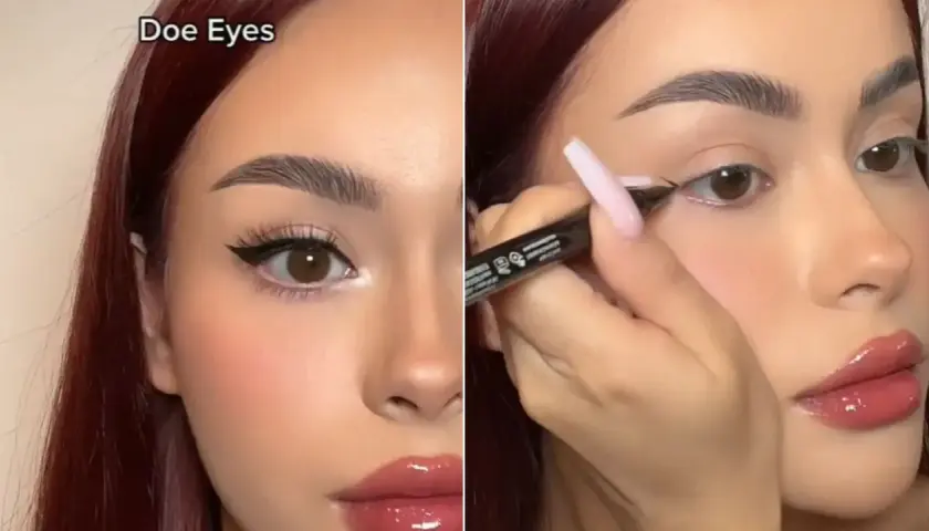 Kobieta z brązowymi oczami i błyszczącymi ustami tworzy makijaż typu "doe eyes", podkreślając spojrzenie eyelinerem.